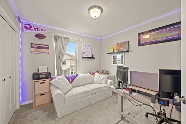 carpeted office featuring a textured ceiling and baseboards