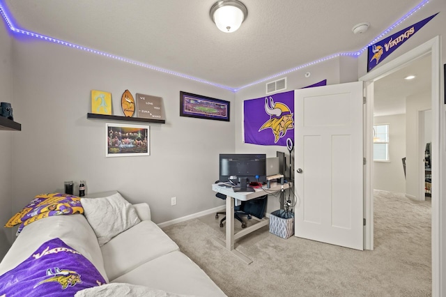 office space featuring a textured ceiling, baseboards, visible vents, and carpet floors