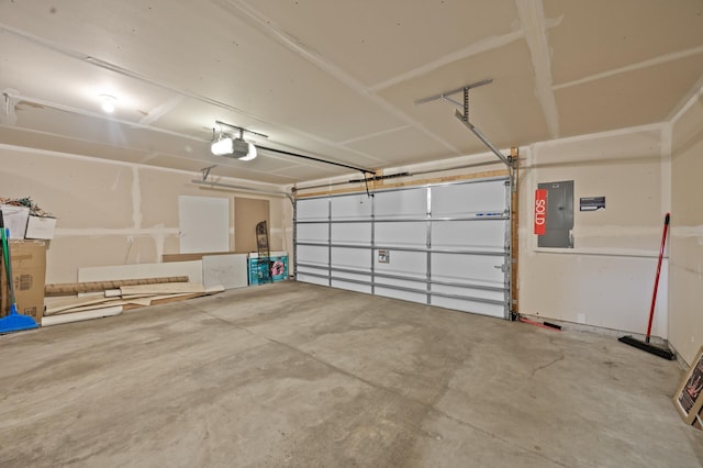 garage with a garage door opener and electric panel