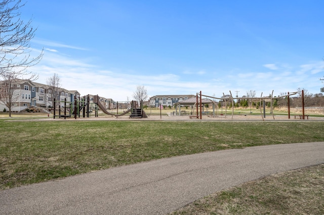 view of home's community with a yard, a residential view, and playground community