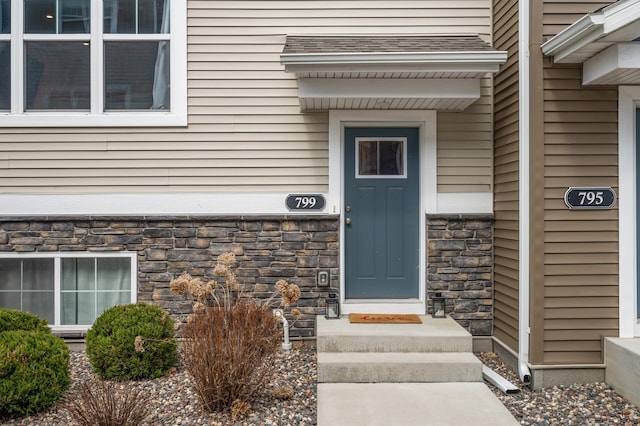 entrance to property featuring stone siding