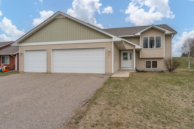 view of front facade with roof with shingles, driveway, an attached garage, and a front lawn