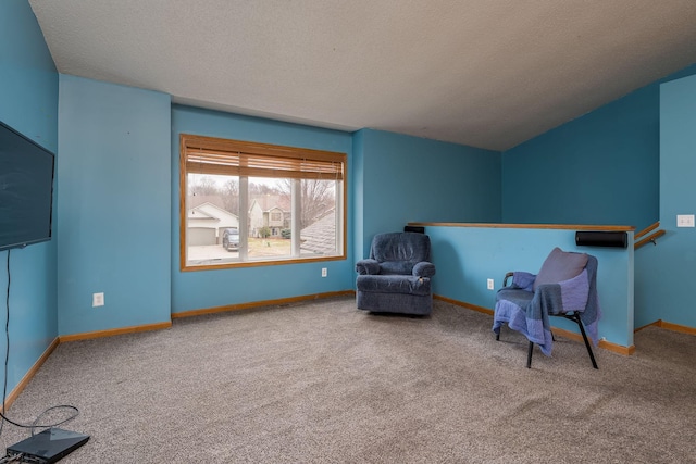 unfurnished room featuring a textured ceiling, baseboards, and carpet floors