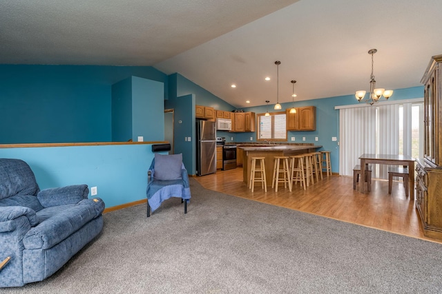 living room featuring recessed lighting, light carpet, lofted ceiling, baseboards, and a notable chandelier