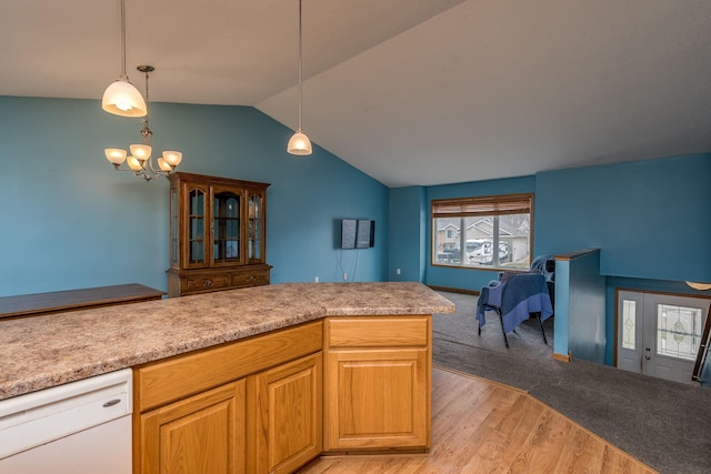kitchen with light wood-style flooring, a healthy amount of sunlight, white dishwasher, and lofted ceiling