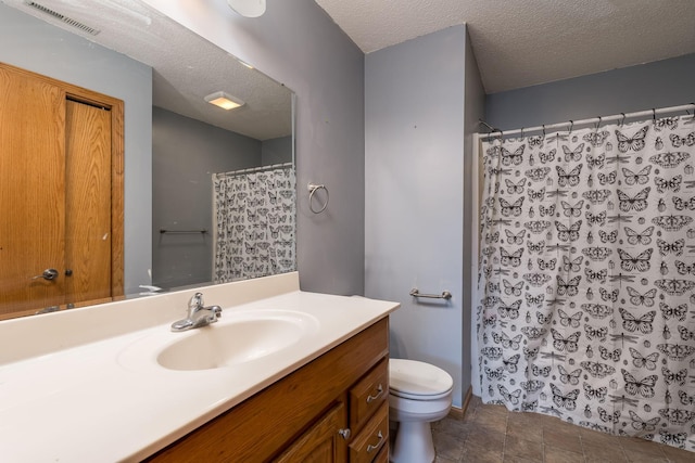 bathroom with toilet, a textured ceiling, vanity, and visible vents