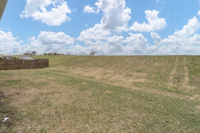 view of yard featuring a rural view and fence