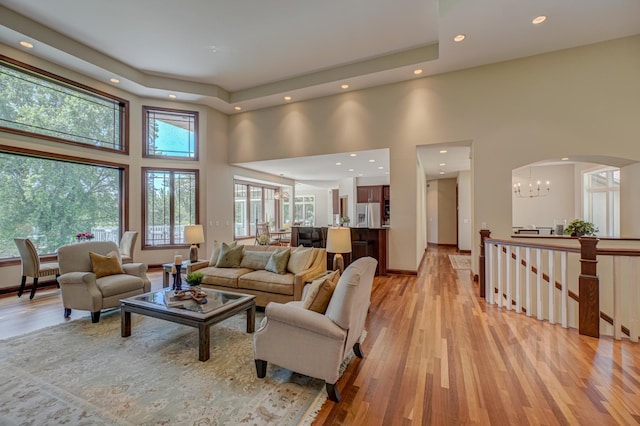 926 Kohlman Ln, Maplewood, MN 55109 - living area with a towering ceiling, light wood-type flooring, recessed lighting, a chandelier, and arched walkways