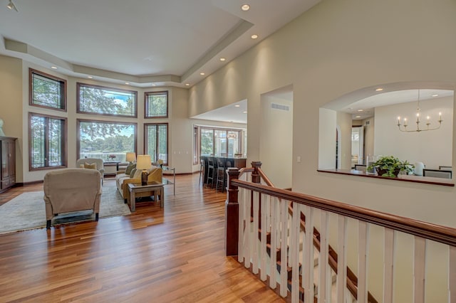 926 Kohlman Ln, Maplewood, MN 55109 - living area featuring a high ceiling, recessed lighting, light wood-style floors, a chandelier, and arched walkways