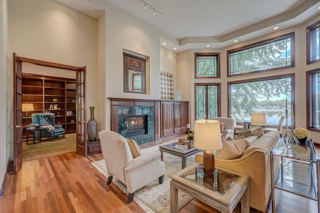 926 Kohlman Ln, Maplewood, MN 55109 - living room featuring a high ceiling, a premium fireplace, healthy amount of natural light, light wood-type flooring, and recessed lighting