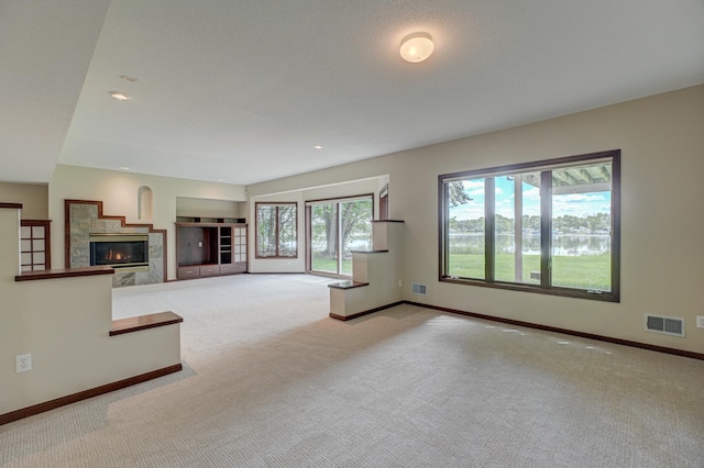 926 Kohlman Ln, Maplewood, MN 55109 - unfurnished living room featuring carpet floors, a fireplace, and a water view