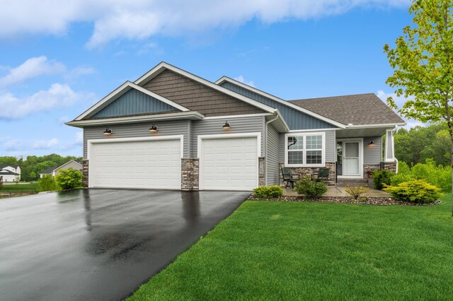 9769 Jeremiah Ct NE, Hanover, MN 55341 - craftsman inspired home with driveway, an attached garage, stone siding, a front lawn, and board and batten siding