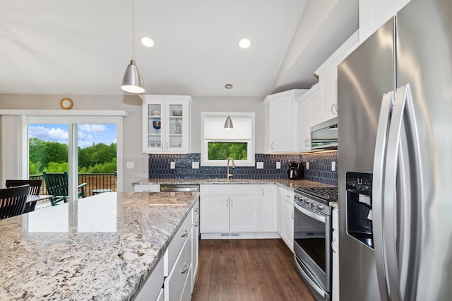 9769 Jeremiah Ct NE, Hanover, MN 55341 - kitchen featuring appliances with stainless steel finishes, a sink, tasteful backsplash, vaulted ceiling, and healthy amount of natural light