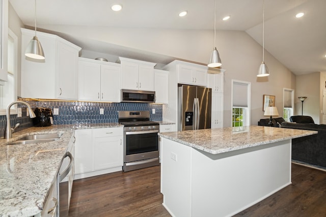 9769 Jeremiah Ct NE, Hanover, MN 55341 - kitchen with appliances with stainless steel finishes, a sink, a center island, decorative backsplash, and light stone countertops