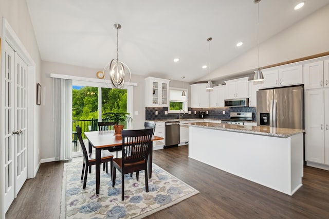 9769 Jeremiah Ct NE, Hanover, MN 55341 - kitchen with stainless steel appliances, plenty of natural light, decorative backsplash, a center island, and lofted ceiling