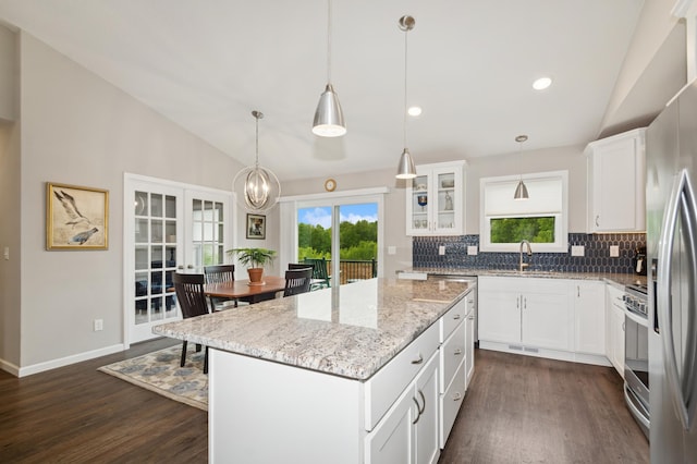 9769 Jeremiah Ct NE, Hanover, MN 55341 - kitchen featuring lofted ceiling, backsplash, dark wood-style flooring, appliances with stainless steel finishes, and a sink