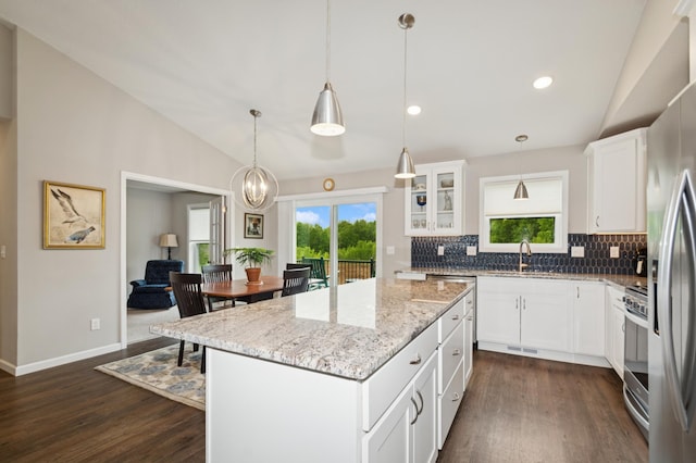 9769 Jeremiah Ct NE, Hanover, MN 55341 - kitchen featuring vaulted ceiling, dark wood finished floors, backsplash, stainless steel appliances, and a sink