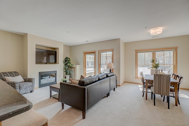 350 Main St N Unit 230, Stillwater, MN 55082 - living area featuring a glass covered fireplace and light colored carpet