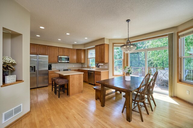 17299 66th Pl N, Maple Grove, MN 55311 - dining room featuring light wood-type flooring, a textured ceiling, plenty of natural light, a chandelier, and recessed lighting