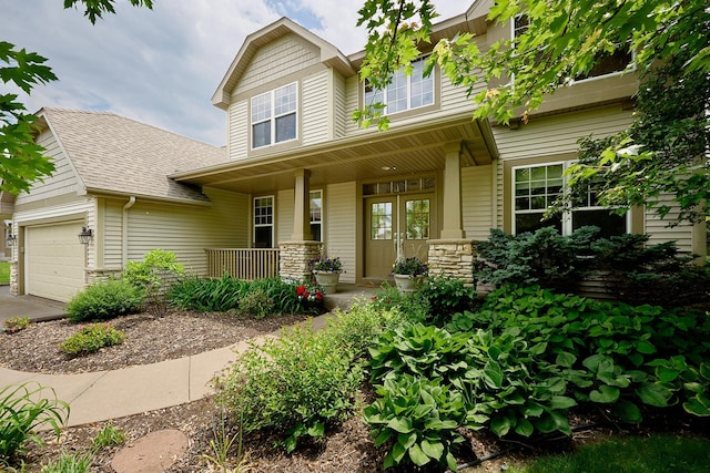 17299 66th Pl N, Maple Grove, MN 55311 - craftsman inspired home featuring covered porch, stone siding, roof with shingles, and an attached garage