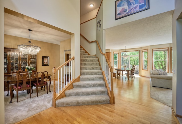 17299 66th Pl N, Maple Grove, MN 55311 - stairway with wood finished floors and a chandelier
