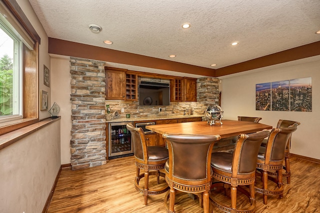 17299 66th Pl N, Maple Grove, MN 55311 - indoor wet bar featuring wine cooler, a textured ceiling, tasteful backsplash, light wood-style flooring, and recessed lighting