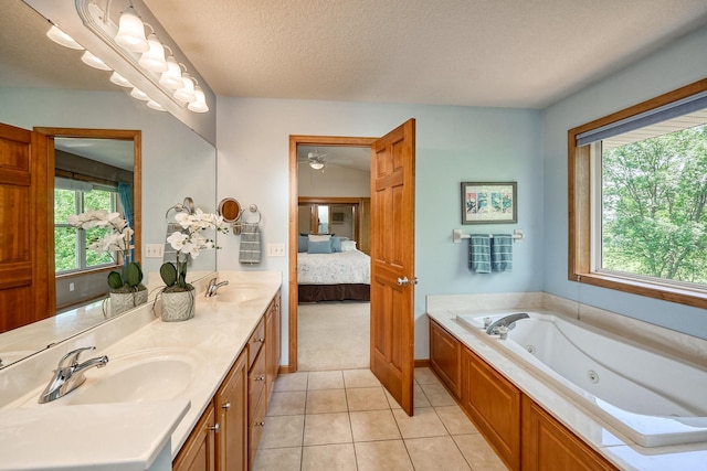 17299 66th Pl N, Maple Grove, MN 55311 - ensuite bathroom featuring double vanity, a tub with jets, tile patterned flooring, ceiling fan, and a textured ceiling