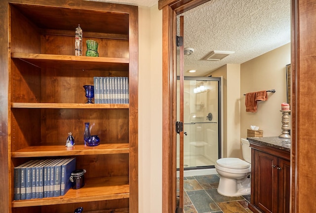 17299 66th Pl N, Maple Grove, MN 55311 - bathroom with a stall shower, a textured ceiling, stone finish floors, and vanity