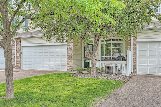 13397 Europa Ct N Unit 5, Hugo, MN 55038 - obstructed view of property with stone siding, a garage, central AC, and a front yard