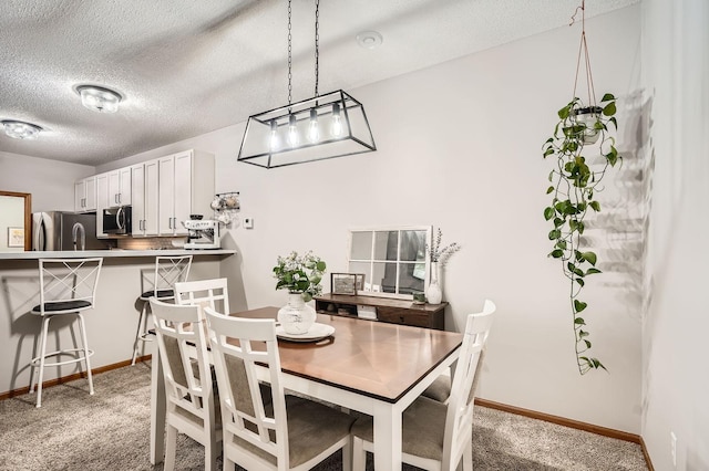13397 Europa Ct N Unit 5, Hugo, MN 55038 - dining area featuring light carpet, a textured ceiling, and baseboards