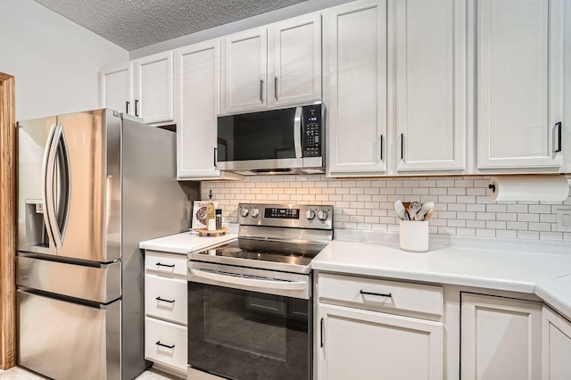 13397 Europa Ct N Unit 5, Hugo, MN 55038 - kitchen with appliances with stainless steel finishes, light countertops, tasteful backsplash, and white cabinets