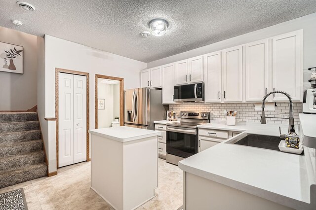 13397 Europa Ct N Unit 5, Hugo, MN 55038 - kitchen featuring appliances with stainless steel finishes, a kitchen island, a sink, backsplash, and light countertops