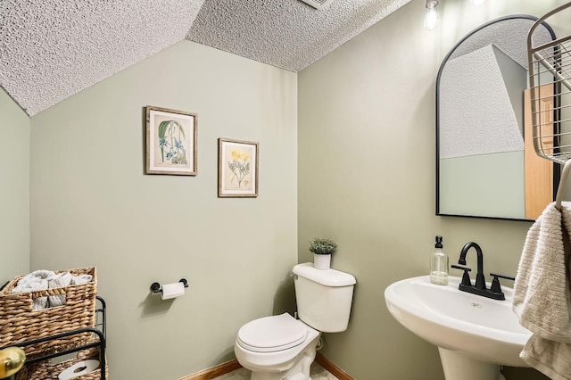 13397 Europa Ct N Unit 5, Hugo, MN 55038 - half bath featuring vaulted ceiling, baseboards, toilet, a textured ceiling, and a sink