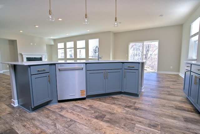 kitchen featuring a sink, light countertops, recessed lighting, and dishwasher