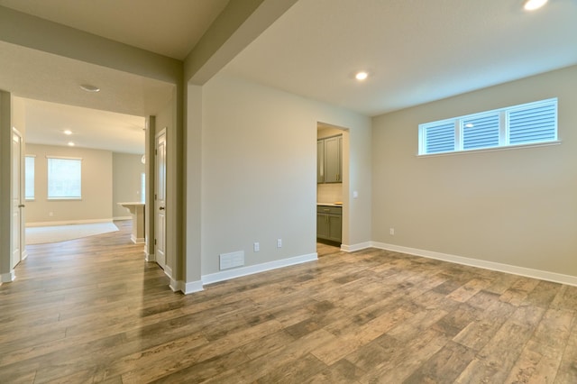 spare room with visible vents, baseboards, recessed lighting, and wood finished floors