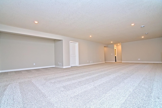 interior space featuring recessed lighting, carpet flooring, a textured ceiling, and baseboards