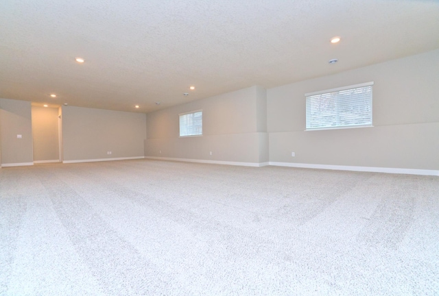 interior space with light carpet, baseboards, and recessed lighting