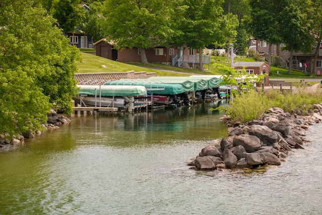 7285 Liens Ln NE Unit 3, Longville, MN 56655 - dock featuring boat lift, a water view, and a lawn