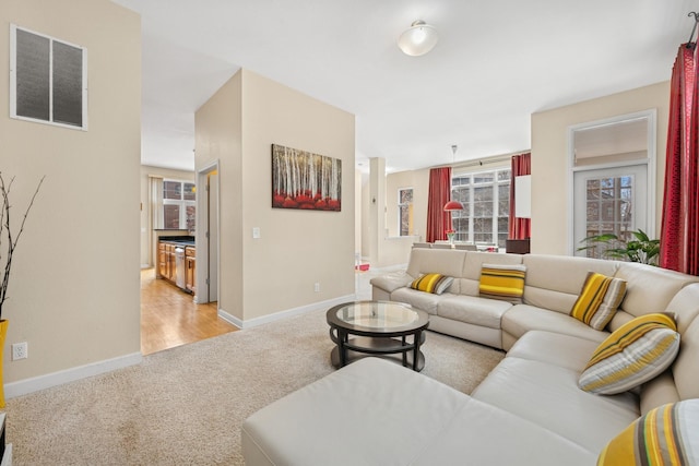 831 River Mews Ct, Minneapolis, MN 55414 - living room featuring light carpet and baseboards