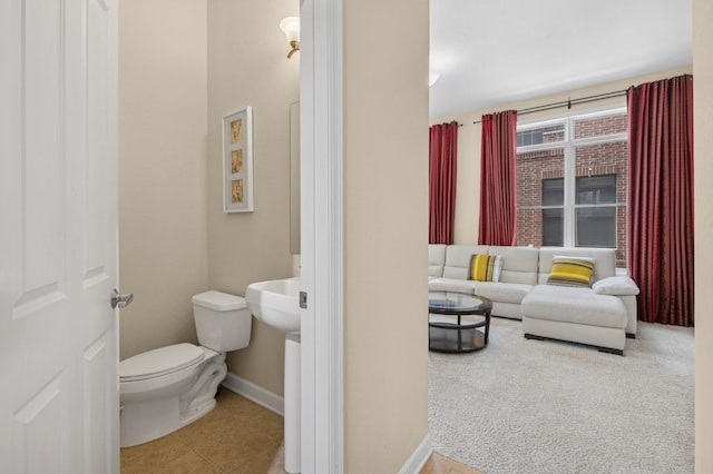 831 River Mews Ct, Minneapolis, MN 55414 - half bathroom featuring toilet and tile patterned floors