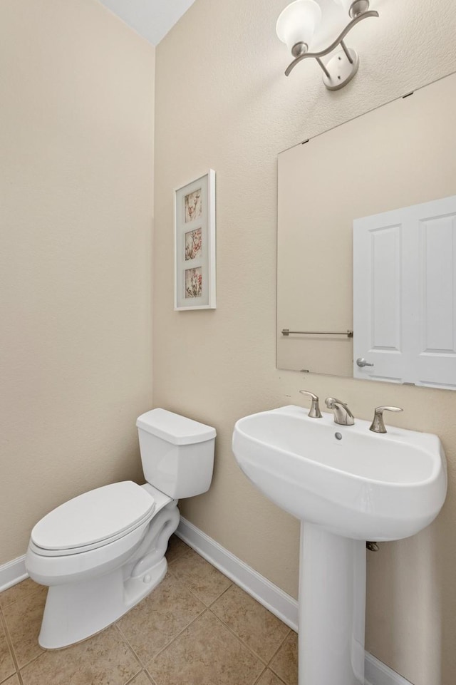 831 River Mews Ct, Minneapolis, MN 55414 - half bathroom with toilet and tile patterned floors