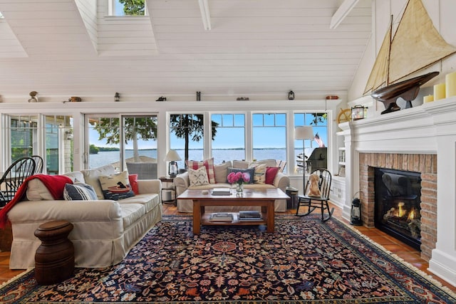 19820 Lakeview Ave, Deephaven, MN 55331 - living area featuring lofted ceiling, a water view, a fireplace, and healthy amount of natural light