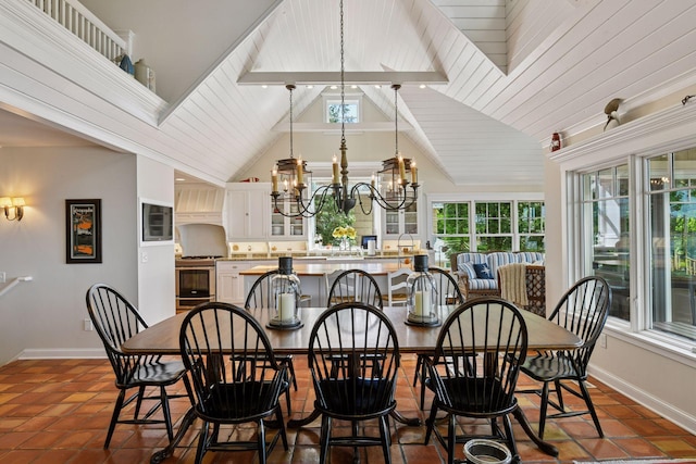 19820 Lakeview Ave, Deephaven, MN 55331 - dining space featuring a chandelier, healthy amount of natural light, high vaulted ceiling, and dark tile patterned flooring