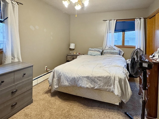 bedroom with baseboard heating and light carpet