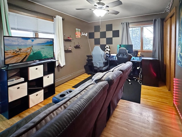 living area featuring a ceiling fan and wood finished floors