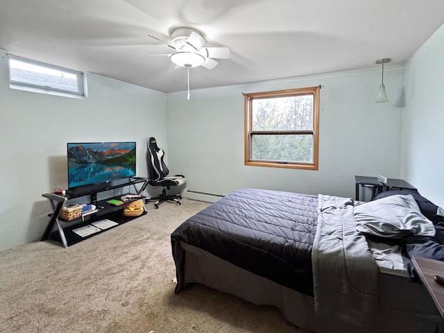 carpeted bedroom with ceiling fan and baseboard heating