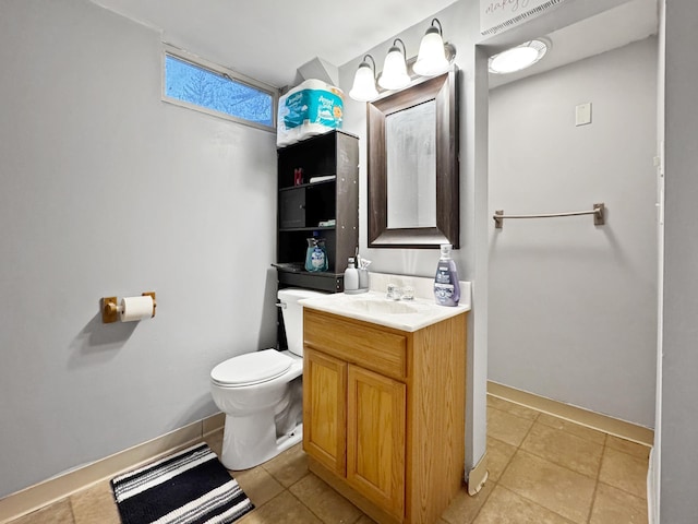 half bathroom featuring tile patterned flooring, baseboards, toilet, and vanity