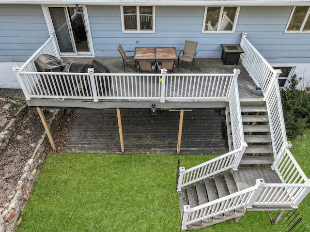 exterior space with stairway, a wooden deck, and outdoor dining space