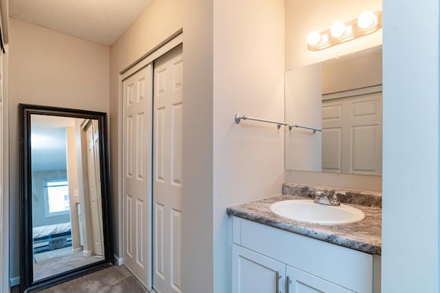 2930 Blaisdell Ave Unit 124, Minneapolis, MN 55408 - bathroom featuring vanity and a textured ceiling