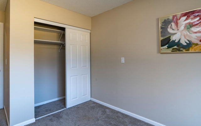 2930 Blaisdell Ave Unit 124, Minneapolis, MN 55408 - unfurnished bedroom featuring carpet flooring, baseboards, and a closet
